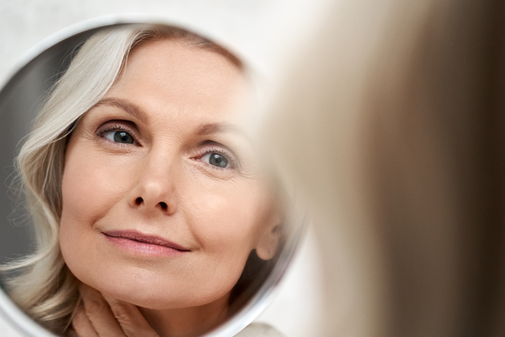 Happy,50s,Middle,Aged,Woman,Model,Touching,Face,Skin,Looking