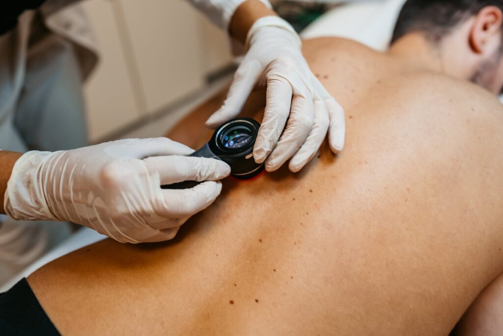 Female Doctor Examining Patients Birthmarks